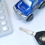 Toy car, calculator, and keys representing Lexus financing