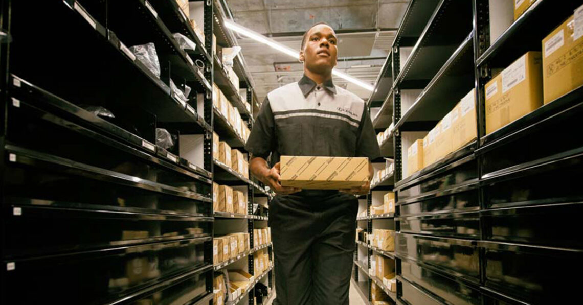 Technician carrying Lexus parts