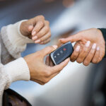 Customer receiving keys at a Lexus dealership