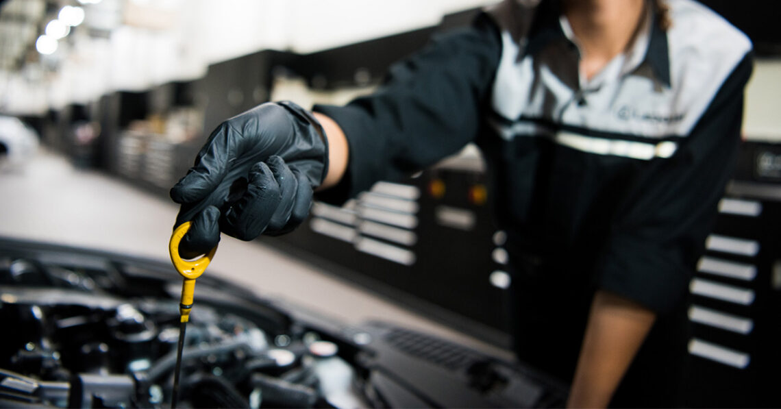 Technician changing oil to improve Lexus fuel efficiency