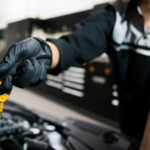 Technician changing oil to improve Lexus fuel efficiency