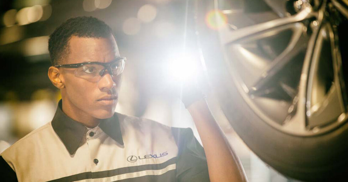 Lexus service technician inspecting a tire