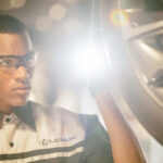 Lexus service technician inspecting a tire