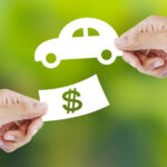 Hands exchanging 2D cash and car representing Lexus trade-in value