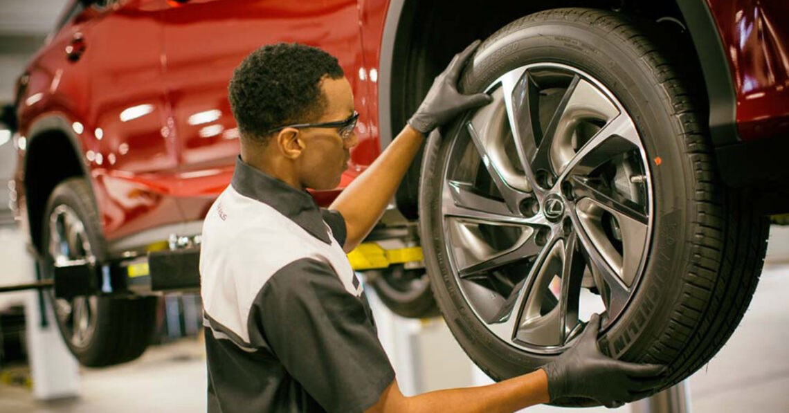 Service technician installing new Lexus tires
