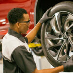 Service technician installing new Lexus tires