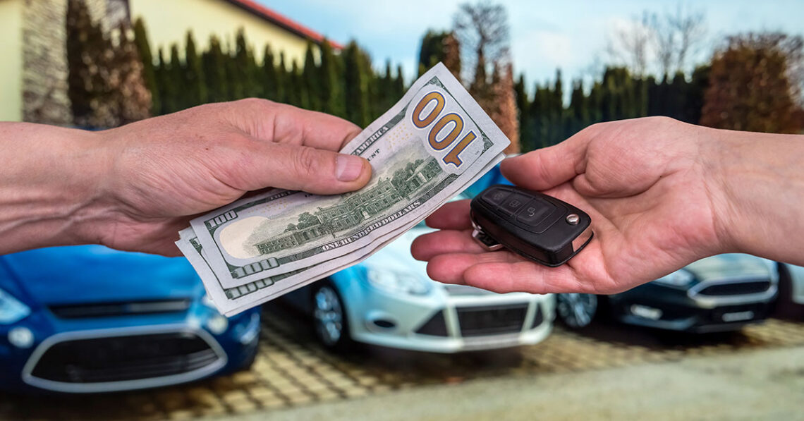Cash and keys exchanging hands as part of Lexus trade-in