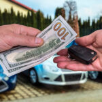 Cash and keys exchanging hands as part of Lexus trade-in