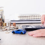 Person calculating financing for a pre-owned Lexus car