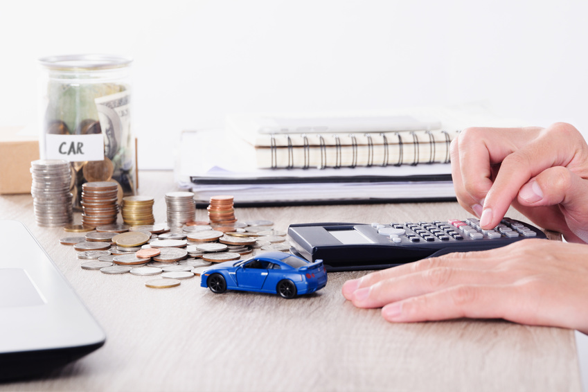 Person calculating financing for a pre-owned Lexus car